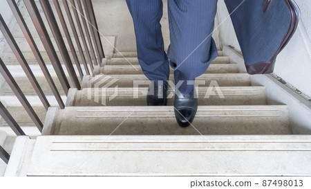 Image of a businessman climbing stairs Image of a businessman climbing stairs 87498013
