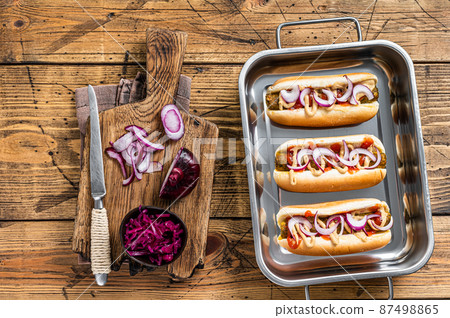 Vegan Vegetarian hot-dogs with onion and meatless sausage. Wooden background. Top view 87498865