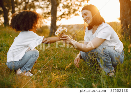 Caucasian mother got a flower from her mixed race daughter Caucasian mother got a flower from her mixed race daughter 87502188