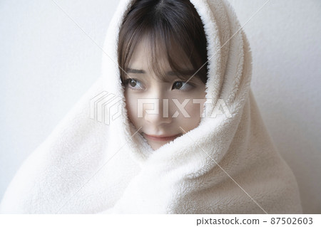 Woman wearing a blanket Woman wearing a blanket 87502603