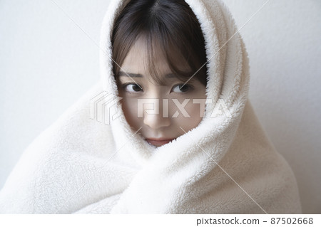 Woman wearing a blanket 87502668