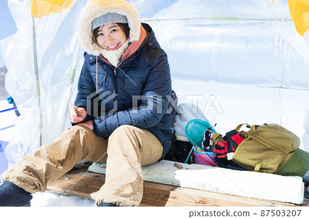A woman enjoying smelt fishing A woman enjoying smelt fishing 87503207
