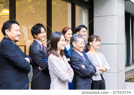 A business person who crosses his arms in front of the office A business person who crosses his arms in front of the office 87503574