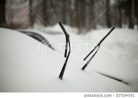 Brushes on car. Car is in snow. Safety of brushes in cold. 87504591