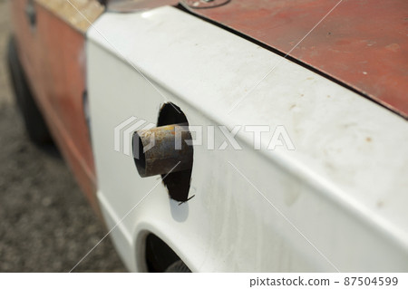 Muffler pipe in race car. Cut hole for exhaust pipe in car. Muffler pipe in race car. Cut hole for exhaust pipe in car. 87504599