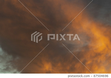 Fiery clouds. Sunset light. Orange sky. Landscape sunset colors. Fiery clouds. Sunset light. Orange sky. Landscape sunset colors. 87504696