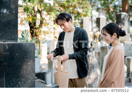 Men and women visiting the grave 87505012