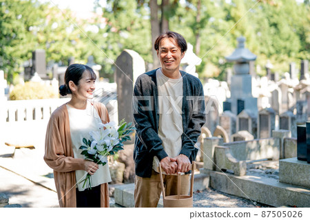 Men and women visiting the grave Men and women visiting the grave 87505026