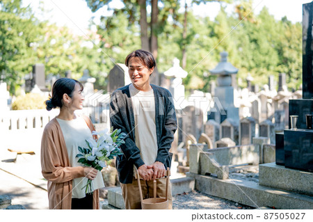 Men and women visiting the grave 87505027