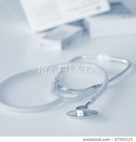 Stethoscope with medication on the table. Concept for health and medicine. Hospital background. 87505225