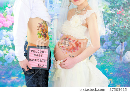 Maternity photo, pregnant woman and husband's stomach up 87505615