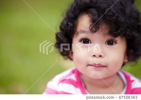 Bright-eyed and filled with potential. Closeup of a beautiful little girl looking away. Bright-eyed and filled with potential. Closeup of a beautiful little girl looking away. 87506365