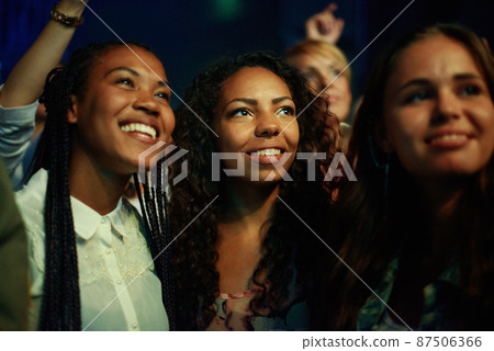 Captivated by the music. Audience members at a concert. Captivated by the music. Audience members at a concert. 87506366