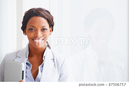 Professional and ambitious. Portrait of a young woman holding a laptop next to her reflection - copyspace. Professional and ambitious. Portrait of a young woman holding a laptop next to her reflection - copyspace. 87506757