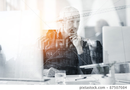 Planning the city with care. Multiple exposure shot of a mature businessman using a laptop superimposed on a cityscape. Planning the city with care. Multiple exposure shot of a mature businessman using a laptop superimposed on a cityscape. 87507084