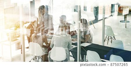 Getting down to business in the city. Multiple exposure shot of businesspeople in an office superimposed on a cityscape. Getting down to business in the city. Multiple exposure shot of businesspeople in an office superimposed on a cityscape. 87507265