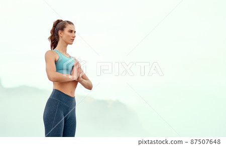 Be at peace with yourself. Shot of a sporty young woman practicing yoga outdoors. 87507648