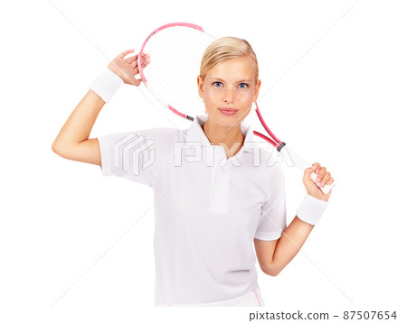 Shes relaxed about the big match. Portrait of a beautiful young woman holding her tennis racquet. 87507654