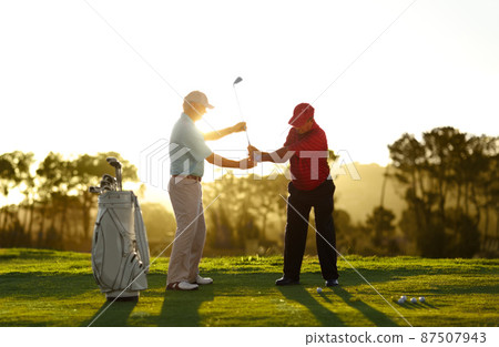 Keep the club level right through your swing. A male golfer receiving help from his caddy on the golf course. Keep the club level right through your swing. A male golfer receiving help from his caddy on the golf course. 87507943