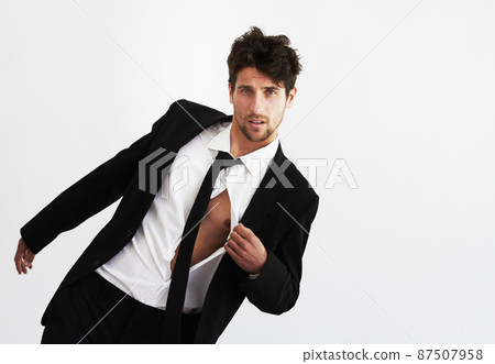 He has that effect on ladies. Portrait of a sexy young man pulling open his unbuttoned shirt wearing a smart balck suit and tie - Copyspace. He has that effect on ladies. Portrait of a sexy young man pulling open his unbuttoned shirt wearing a smart balck suit and tie - Copyspace. 87507958