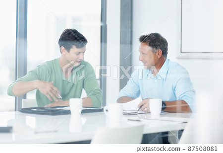 Getting creative. A young advertising executive pitching and idea to his boss. 87508081