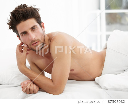 The lazy look. Portrait of a handsome male waking up to the morning sunshine. 87508082