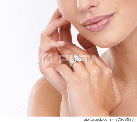 The perfect wedding ring. Cropped view of a young womanamp039s hands wearing a diamond ring. The perfect wedding ring. Cropped view of a young womanamp039s hands wearing a diamond ring. 87508086