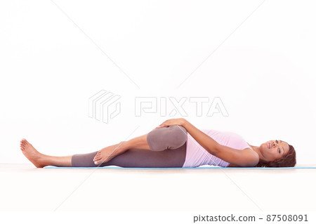 Working every muscle and joint. A young african-american woman performing a yoga routine. 87508091