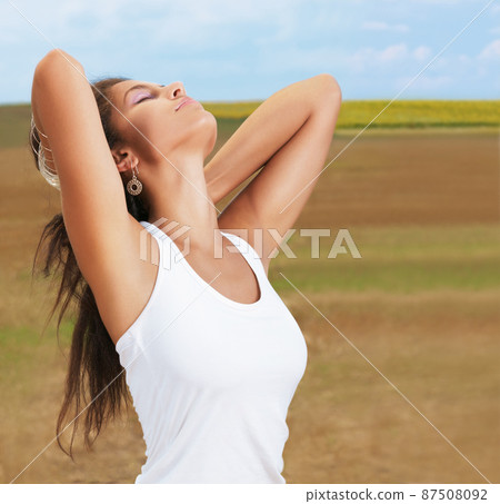 Feeling fabulously free. Shot of a beautiful young woman enjoying a day in nature. 87508092