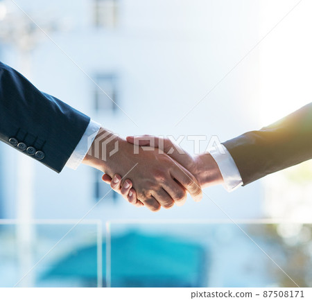 Lets shake on it. Shot of two businesspeople shaking hands. 87508171
