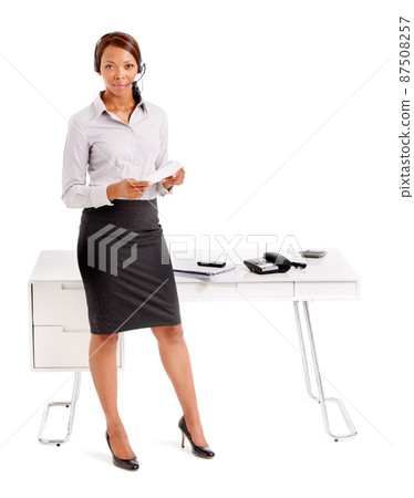 Confident and in charge. An ethnic business woman standing in front of her desk. 87508257