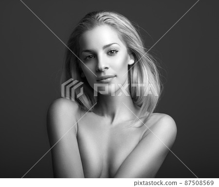 Shes not shy at all. Black and white portrait of an attractive young woman posing topless in studio. 87508569