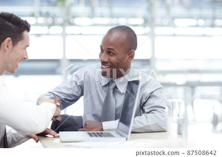 Youve got yourself a deal. Two businessmen shaking hands as they reach an agreement. 87508642