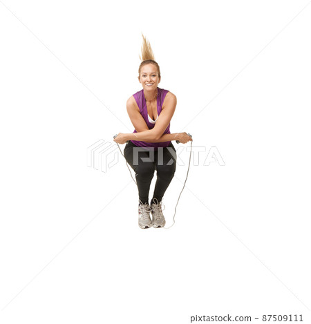 Fun for all ages. Portrait of an attractive young woman skipping. Fun for all ages. Portrait of an attractive young woman skipping. 87509111