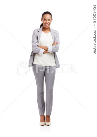 She knew how to get your attention. Full length shot of an attractive young woman standing in a studio with her arms crossed. 87509452