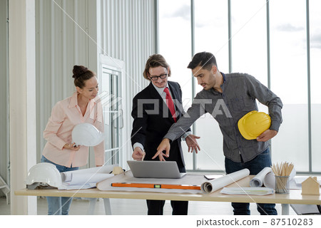 Team of male and female engineers and architects, working team, meeting, discussing construction and drawing construction plans, printing, writing on-site construction sites Team of male and female engineers and architects, working team, meeting, discussing construction and drawing construction plans, printing, writing on-site construction sites 87510283