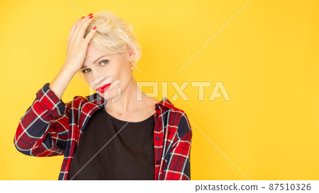 Facepalm gesture. Confused woman. Clueless situation. Embarrassed beautiful lady covering face with hand feeling epic fail isolated yellow copy space. Facepalm gesture. Confused woman. Clueless situation. Embarrassed beautiful lady covering face with hand feeling epic fail isolated yellow copy space. 87510326