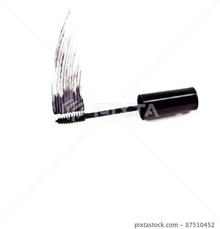 The drama of mascara. Studio shot of a mascara brush smearing makeup against a white background. The drama of mascara. Studio shot of a mascara brush smearing makeup against a white background. 87510452