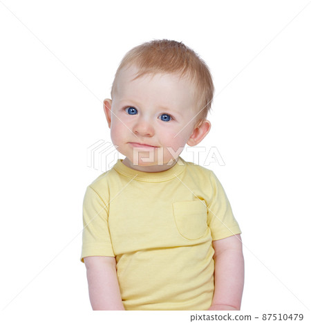 Curious kid. Studio shot of a cute baby boy in a yellow shirt. Curious kid. Studio shot of a cute baby boy in a yellow shirt. 87510479