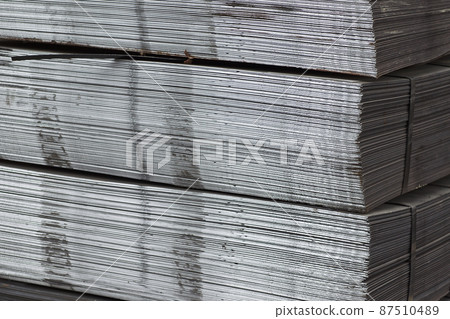 Sheet metal is in bundles in the warehouse 87510489