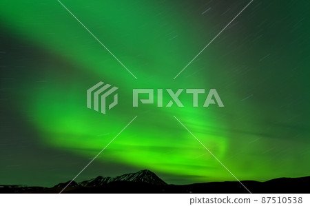 Aurora borealis long exposure, star trail and mountain peak Aurora borealis long exposure, star trail and mountain peak 87510538