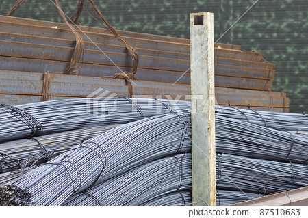 Reinforcing bars with a periodic profile in the packs are stored in the metal products warehouse Reinforcing bars with a periodic profile in the packs are stored in the metal products warehouse 87510683