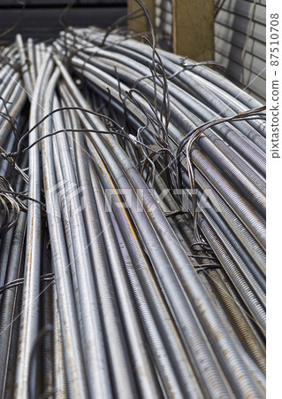 Reinforcing bars with a periodic profile in the packs are stored in the metal products warehouse Reinforcing bars with a periodic profile in the packs are stored in the metal products warehouse 87510708