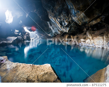 Blue waters of Grjotagja Cave in Iceland Blue waters of Grjotagja Cave in Iceland 87511275