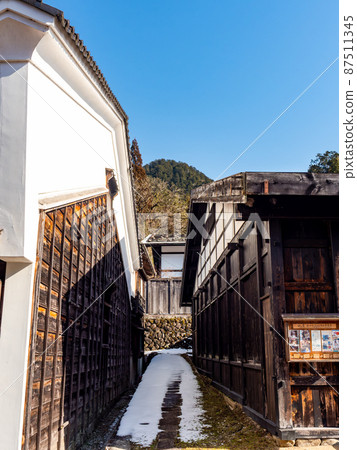 Scenery of Tsumago-juku in winter, sunny in February, alleys of quaint cityscape Scenery of Tsumago-juku in winter, sunny in February, alleys of quaint cityscape 87511345