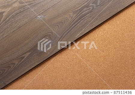 Laminate wood floor at cork background texture. Wooden laminate floor and corkboard with Laminate wood floor at cork background texture. Wooden laminate floor and corkboard with 87511436