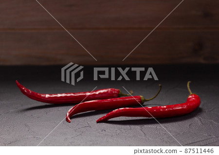 Chile pepper for homemade cooking at table. Recipe concept in kitchen Chile pepper for homemade cooking at table. Recipe concept in kitchen 87511446