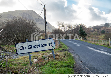 An Ghaeltacht road sign explaining that here starts an area where the irish language is spoken - Translation: Irish 87511774