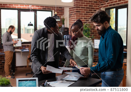 Multi-ethnic businesspeople discussing company collaboration Multi-ethnic businesspeople discussing company collaboration 87511800