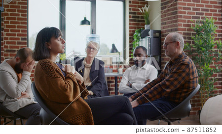 Woman making confession and crying in front of people at aa rehab meeting 87511852